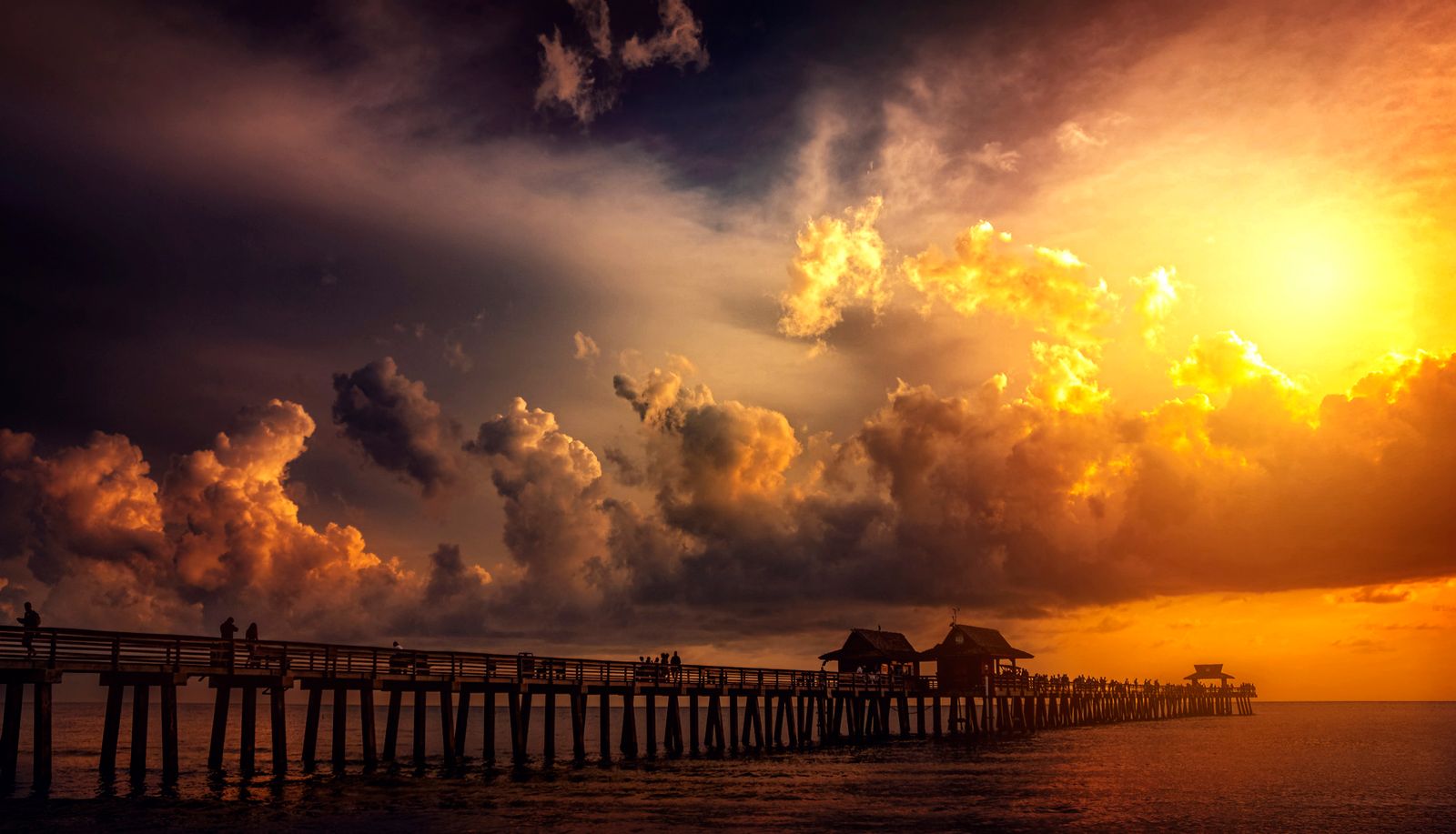 A Gulf pier at golden hour, representative of the Naples and Collier coast