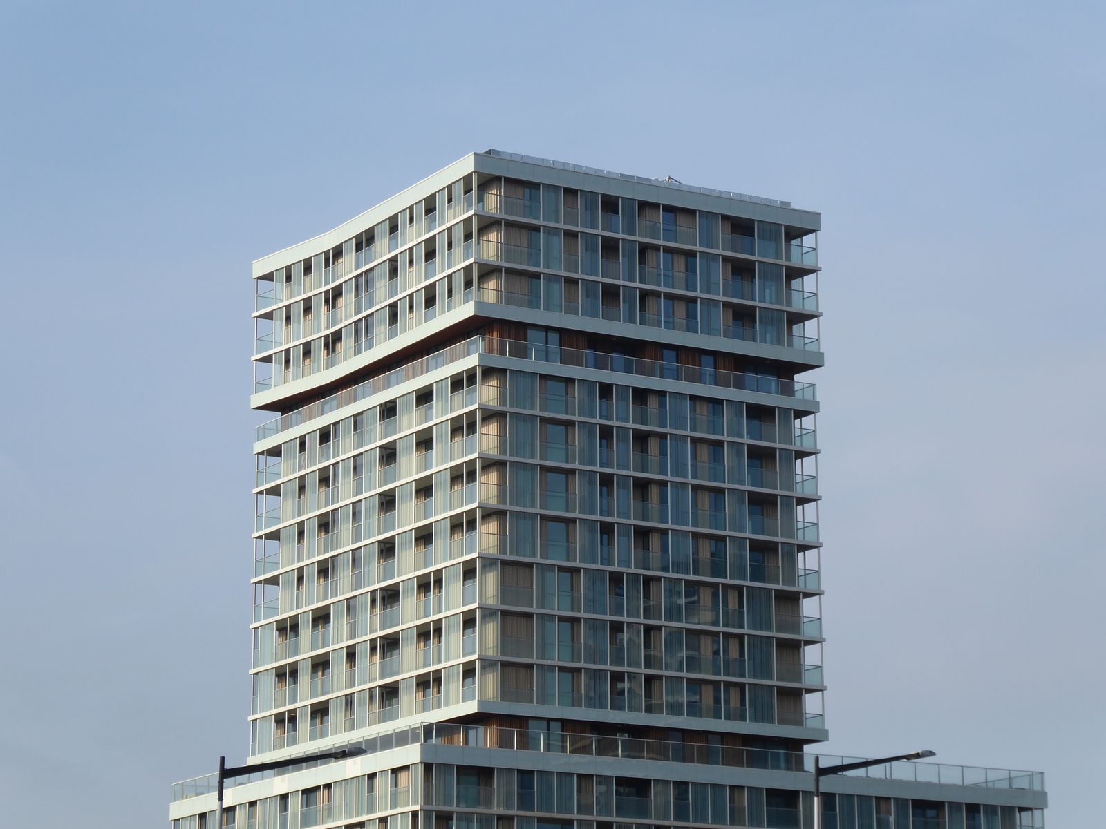 A modern mixed-use building facade, representative of New Rochelle's transit-oriented development